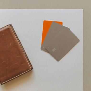 A leather wallet and credit cards on a minimalist background, ideal for financial themes.