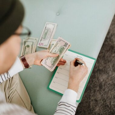 Individual budgeting with US dollars and a planner, focusing on financial planning.